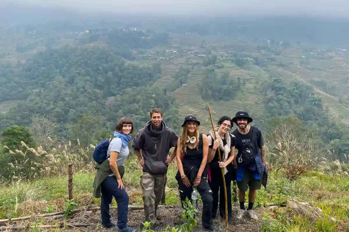 Full-day Sapa valley trek group crossing a footbridge between ethnic minority villages in Lao Cai