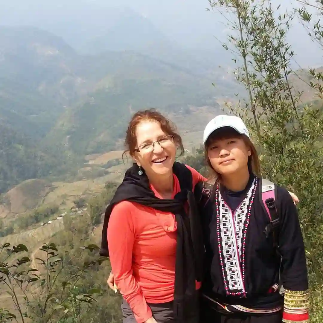 Sapa guide leading a small walking group through rice terraces on the Sapa Countryside Walk