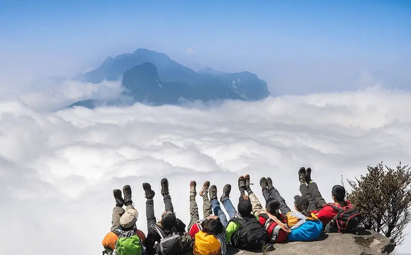 Cloud-covered Fansipan peak above Sapa — summit reachable by multi-day trek or Sun World cable car