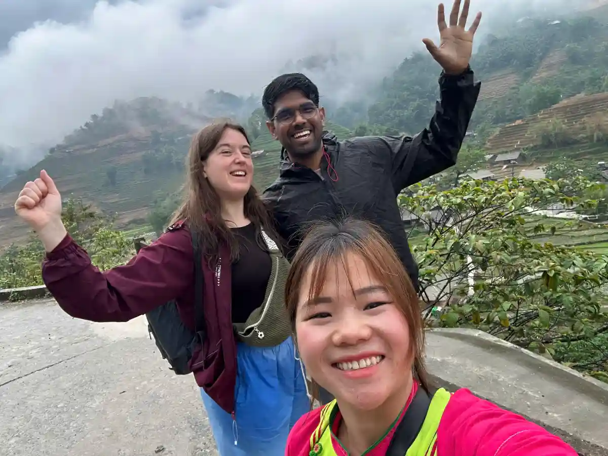SapaTreks guide with guests on a misty Muong Hoa Valley viewpoint