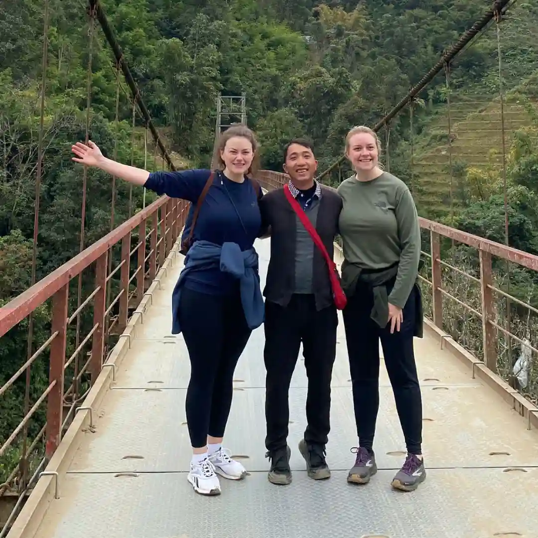 Local guide with travellers trekking through Lao Chai rice terraces near Sapa
