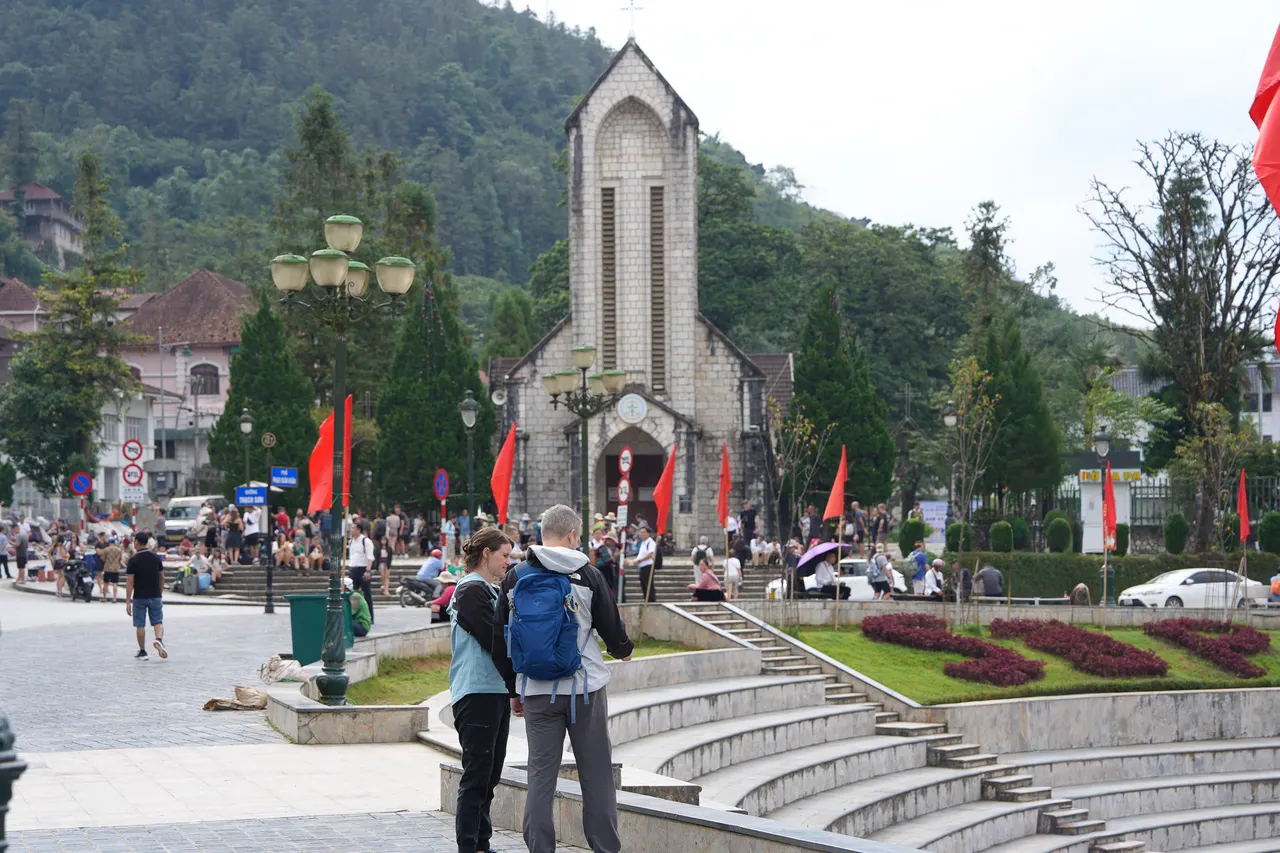 Travellers in front of Sapa Stone Church in Sapa town centre
